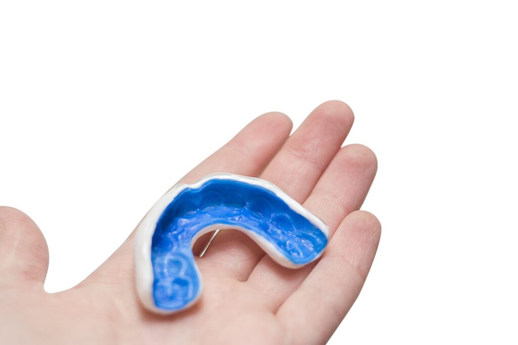 White custom sport mouthguard on a hand. Individual professional sport equipment. Custom mouthguard general dentistry dentist in Lansdale Pennsylvania